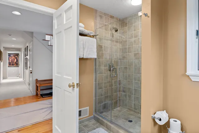 a view of a hallway with wooden cabinets