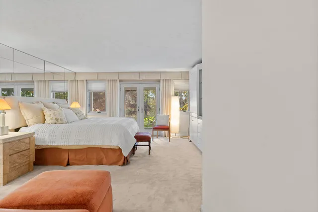 a view of balcony with a large window and couches in the patio