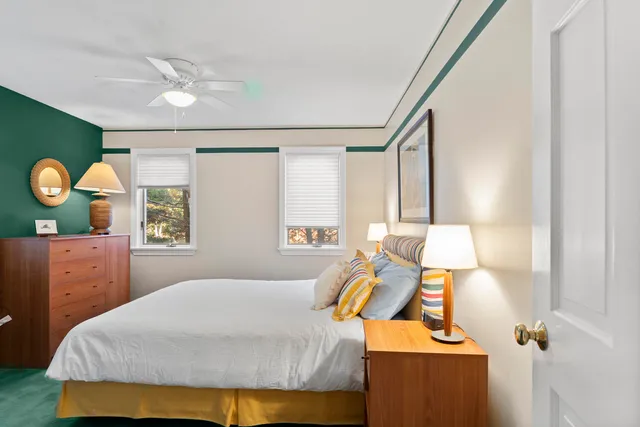 a bedroom with a large bed and a chandelier