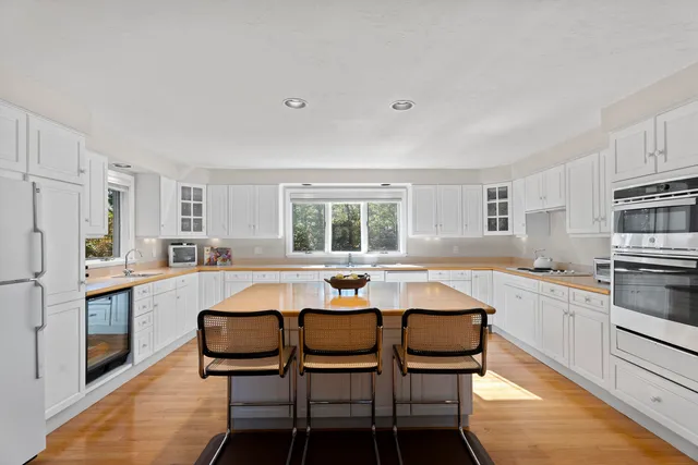 a kitchen with stainless steel appliances granite countertop a stove a sink and a refrigerator