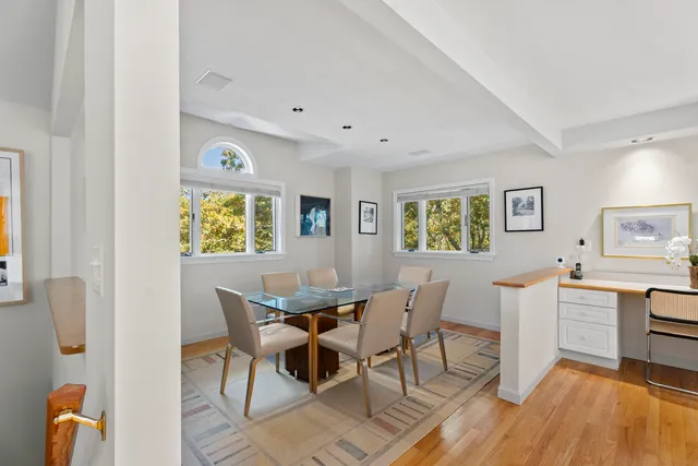 a view of a dining room with furniture and a window