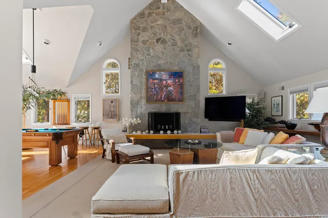 a living room with furniture a fireplace and a flat screen tv