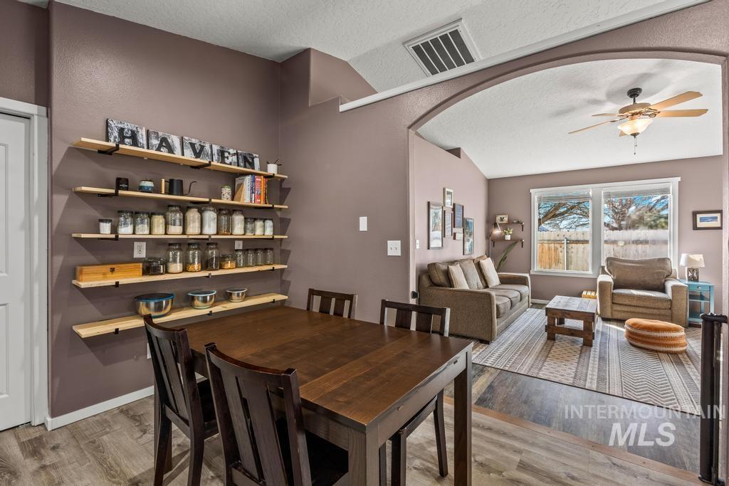 1206 Flint Drive Caldwell, ID 83607 - Photo 9 of 20 Dining area with a ceiling fan, light wood-type flooring, and arched walkways