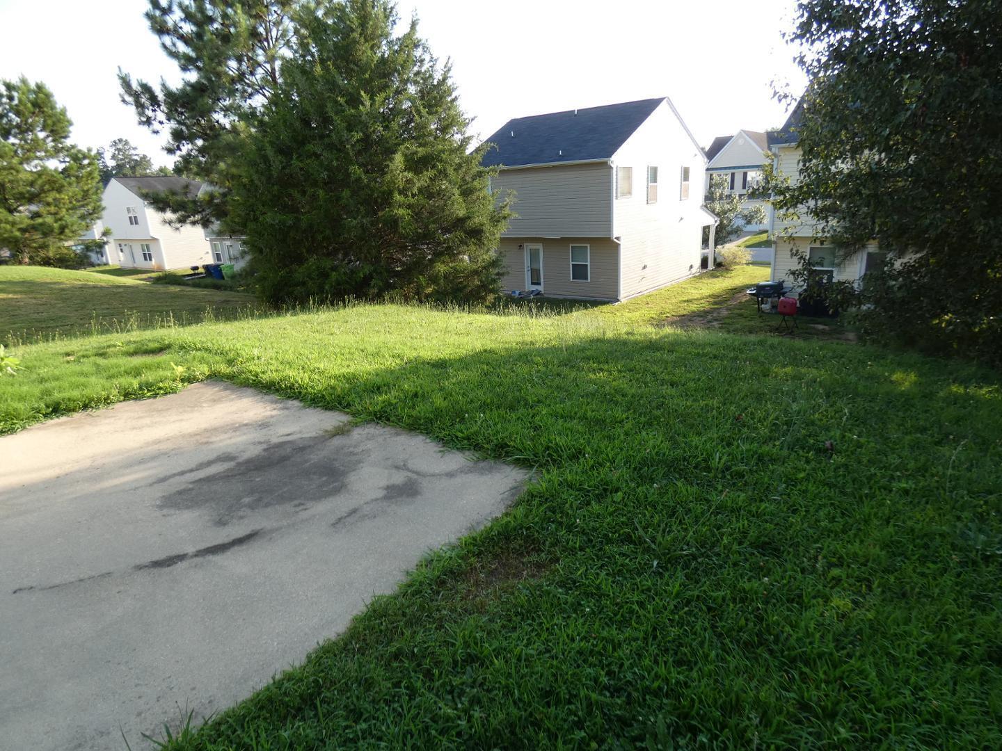 1624 Brown Owl Drive Raleigh, NC 27610 - Photo 22 of 22 a view of a house with a yard and a large tree