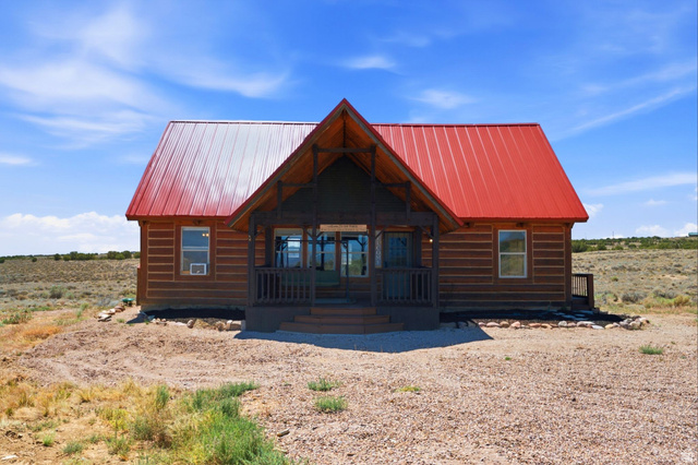 10937 South County Road, Unit 29 Duchesne, UT 84021 - Photo 28 of 41 Log cabin style exterior featuring a vibrant red metal roof