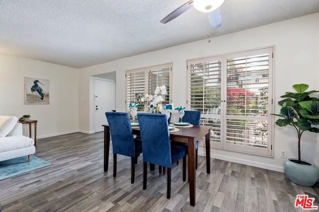 a living room with furniture a fireplace a flat screen tv and a window