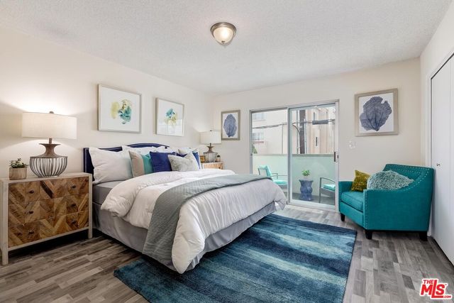 a bedroom with bed and cabinet