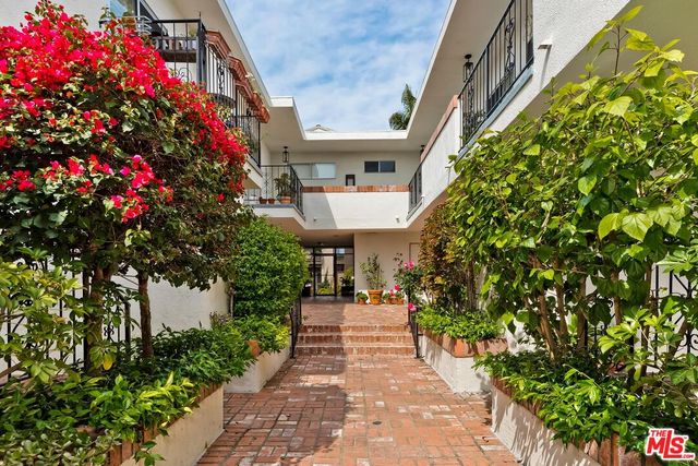 a view of a house with potted plants