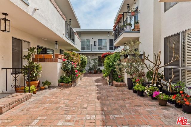 a living room with furniture a fireplace and a wooden floor
