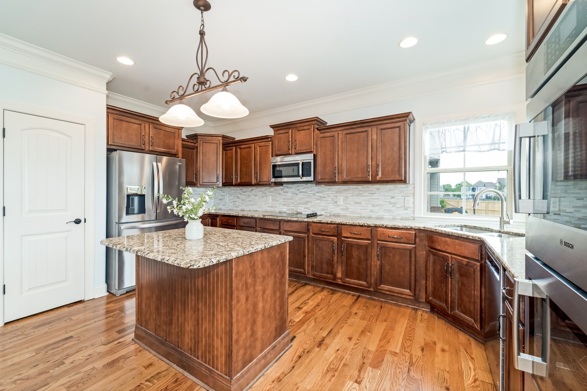 3008 Sakari Circle Spring Hill, TN 37174 - Photo 13 of 44 a kitchen with stainless steel appliances granite countertop wooden cabinets sink and stove