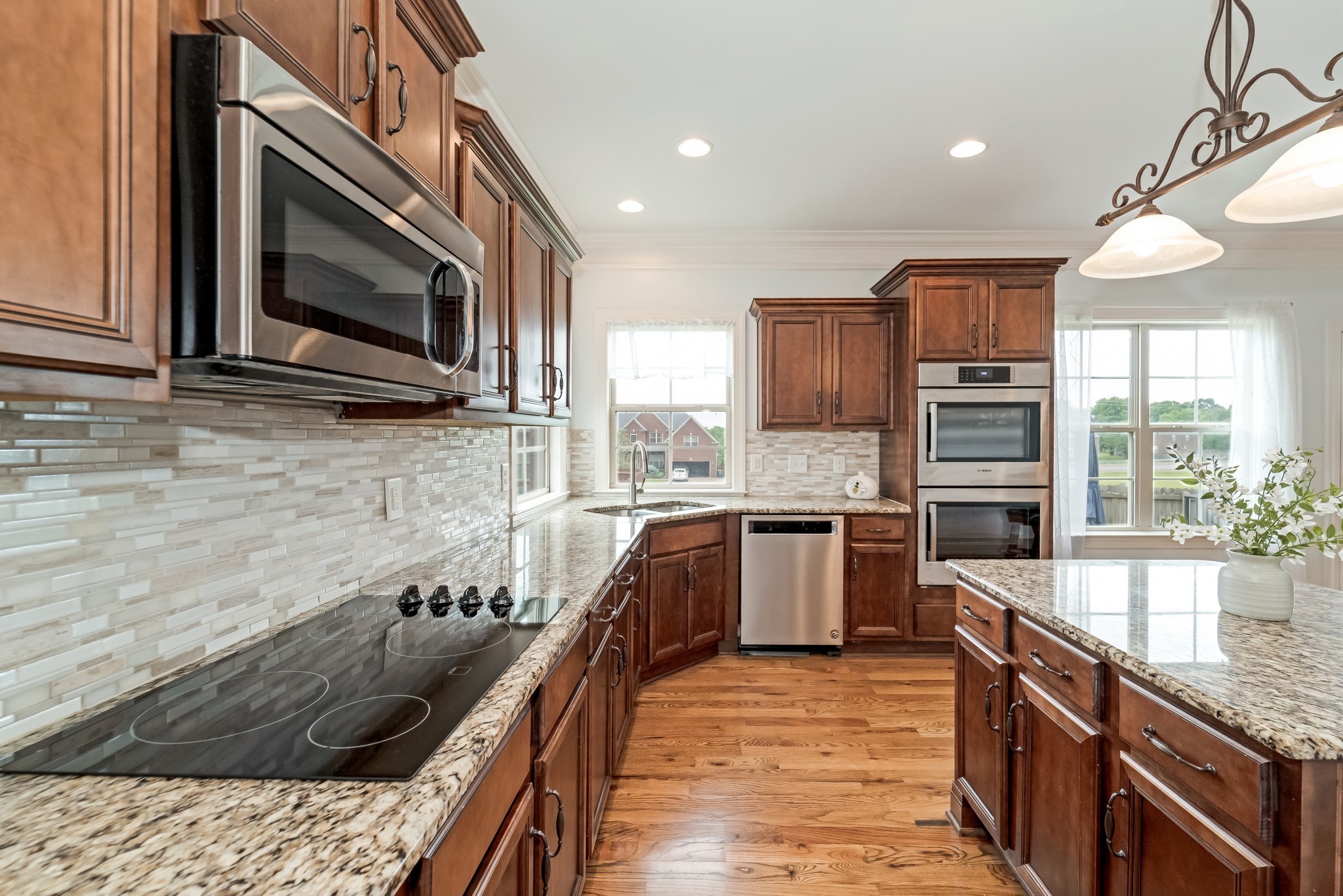 3008 Sakari Circle Spring Hill, TN 37174 - Photo 15 of 44 a kitchen with stainless steel appliances granite countertop a sink a stove and a wooden cabinets