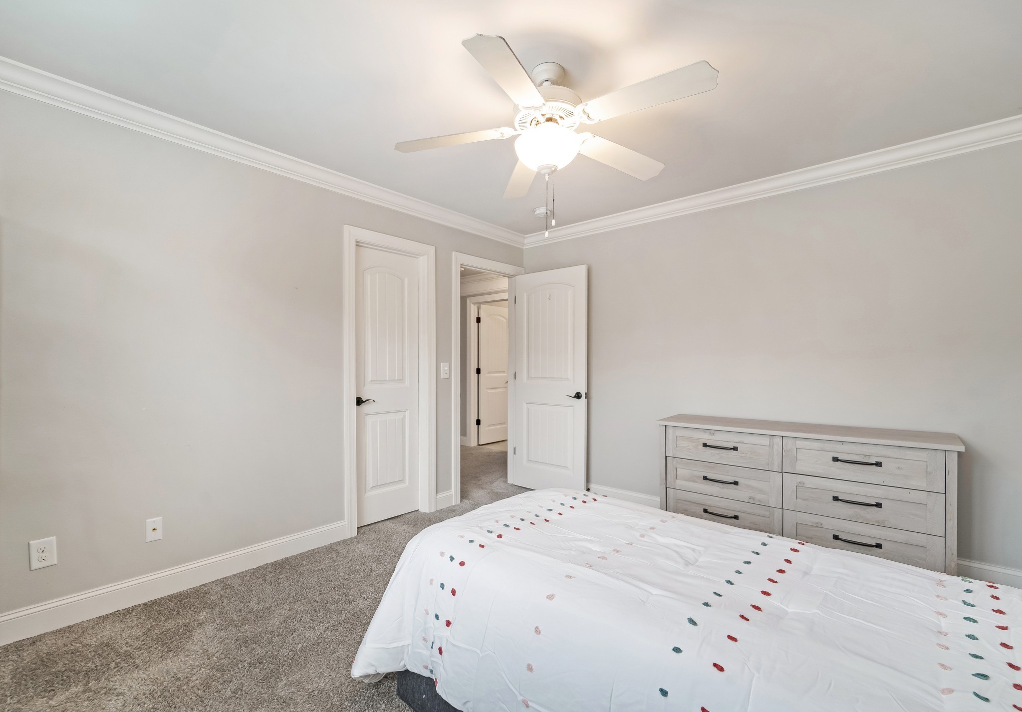 3008 Sakari Circle Spring Hill, TN 37174 - Photo 36 of 44 a bedroom with a bed and a chandelier fan