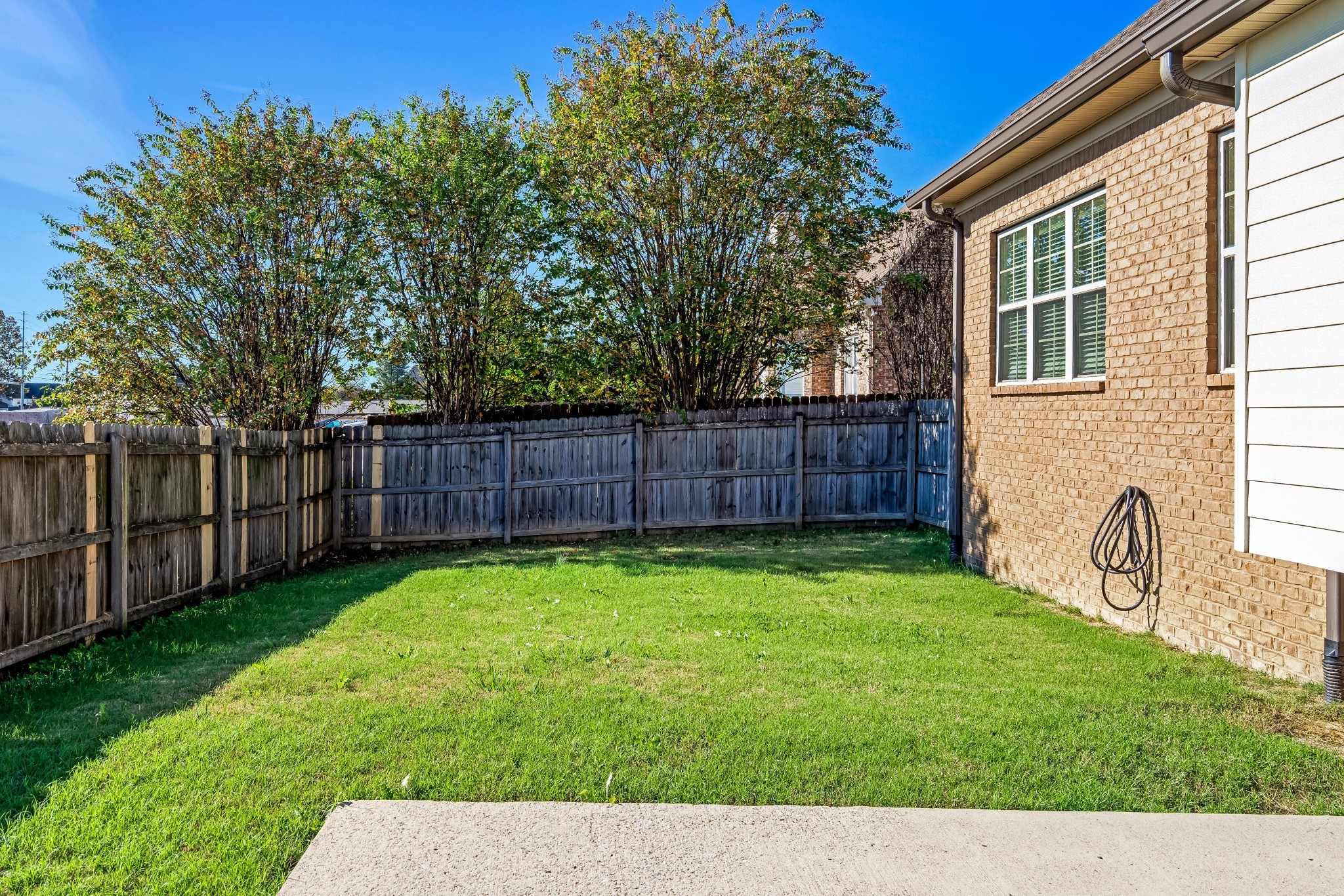 3008 Sakari Circle Spring Hill, TN 37174 - Photo 39 of 44 a view of a backyard with table and chairs and wooden fence