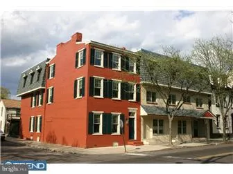 a front view of a residential apartment building with a yard