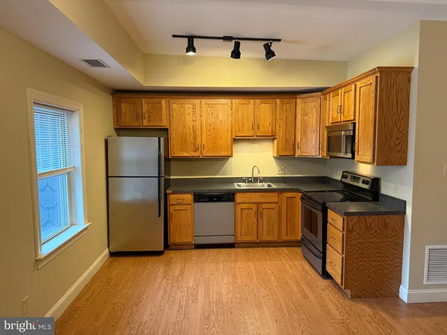 a kitchen with a refrigerator and a sink