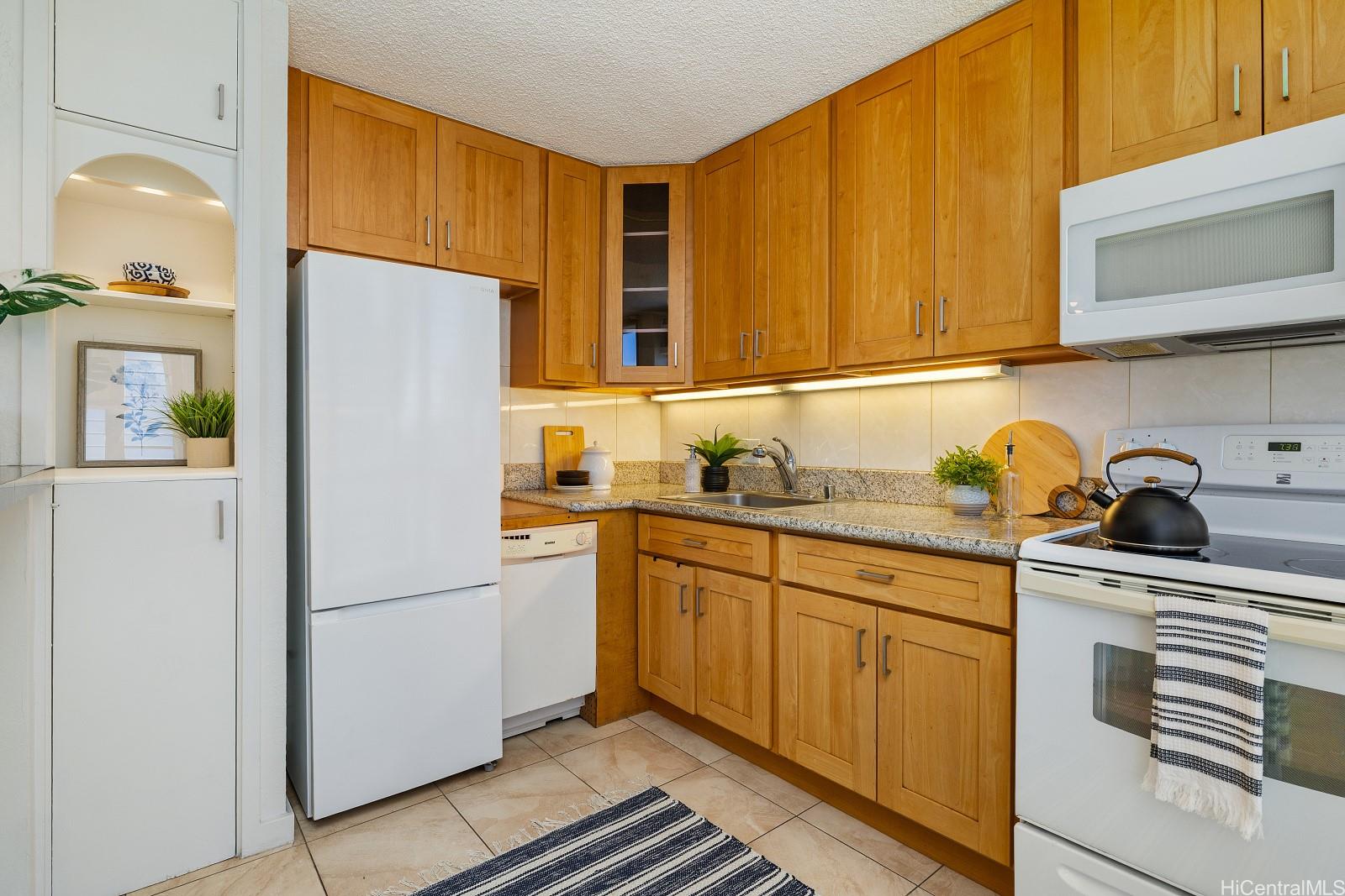 620 McCully Street, Unit 703 Honolulu, HI 96826 - Photo 6 of 25 A cute kitchen with an apt sized dishwasher and coffee bar area.