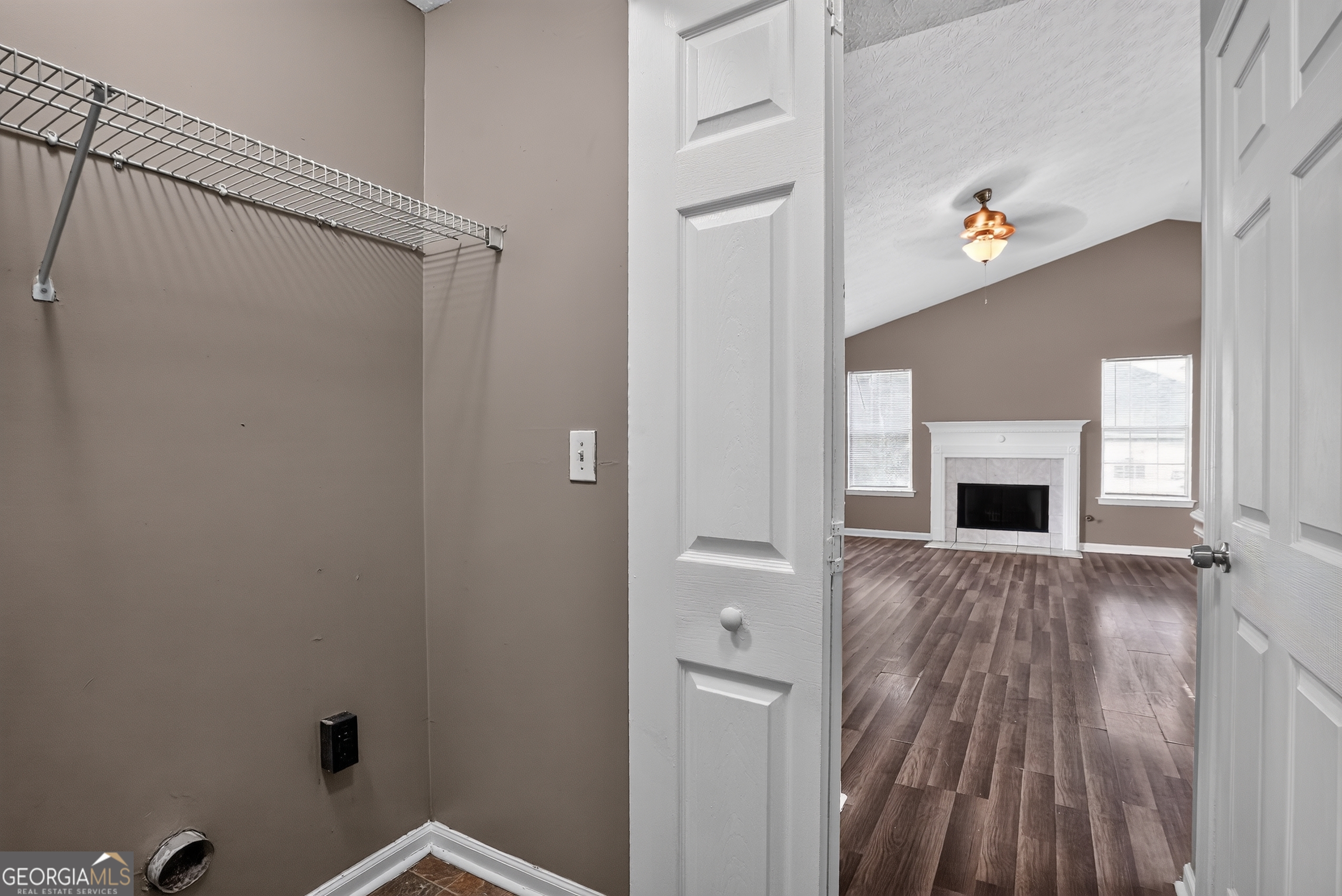 75 Linsley Way Covington, GA 30016 - Photo 41 of 48 a view of a hallway with wooden floor and a fireplace