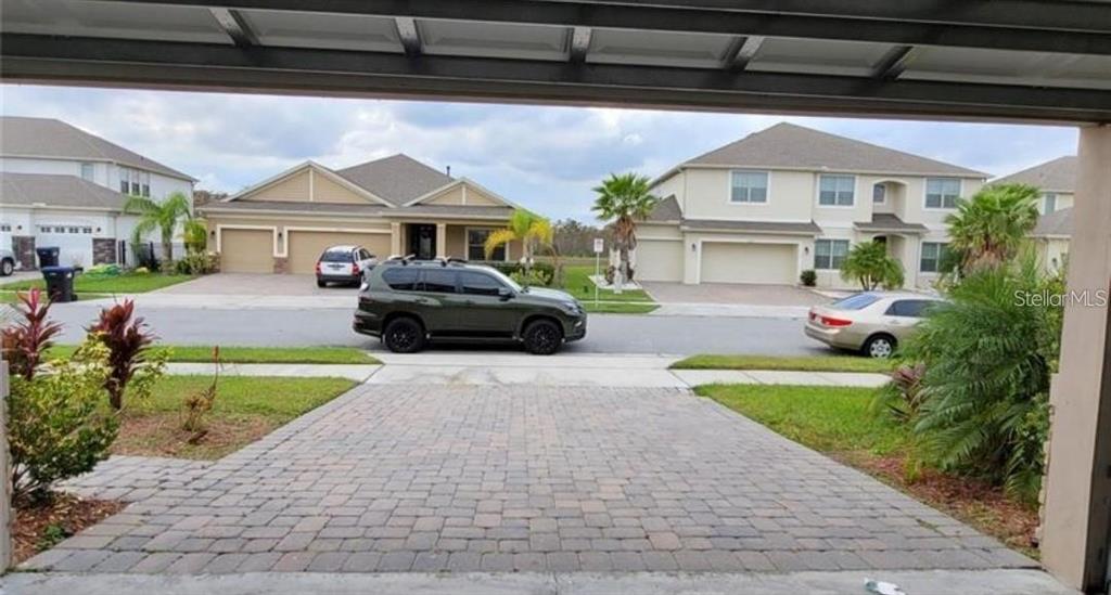 4025 Scarlet Branch Road Orlando, FL 32824 - Photo 4 of 13 a front view of a house with a garden