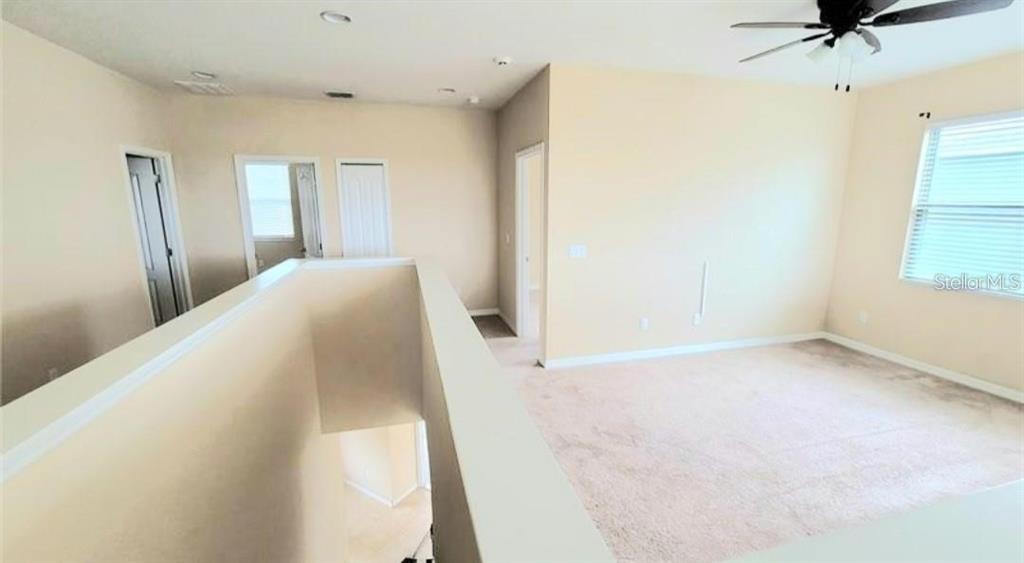 4025 Scarlet Branch Road Orlando, FL 32824 - Photo 8 of 13 a view of empty room with windows