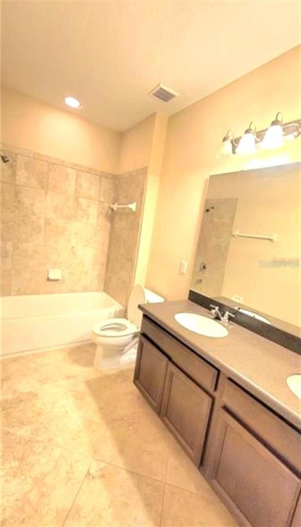 4025 Scarlet Branch Road Orlando, FL 32824 - Photo 10 of 13 a bathroom with a tub sink and vanity