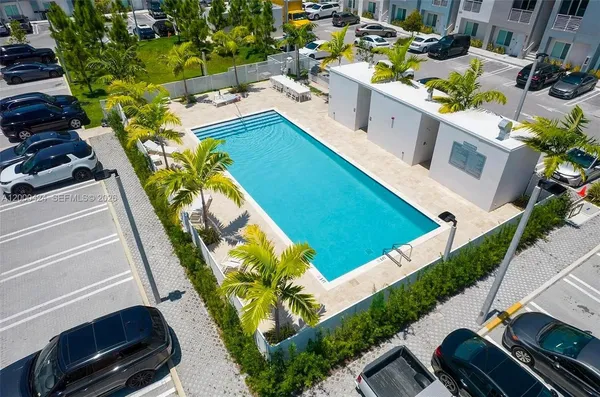 a swimming pool with outdoor seating and yard