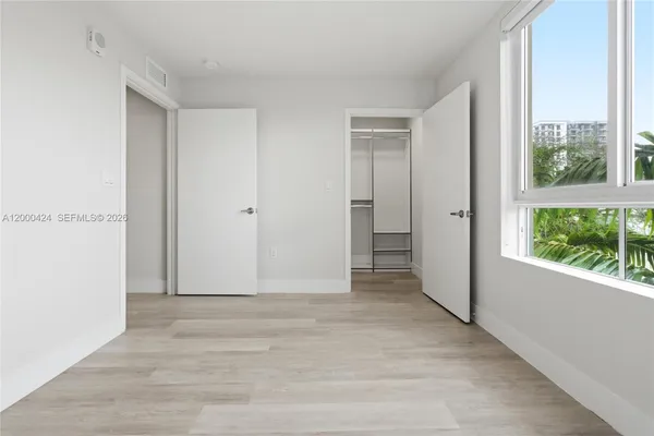 a view of walk in closet with empty racks