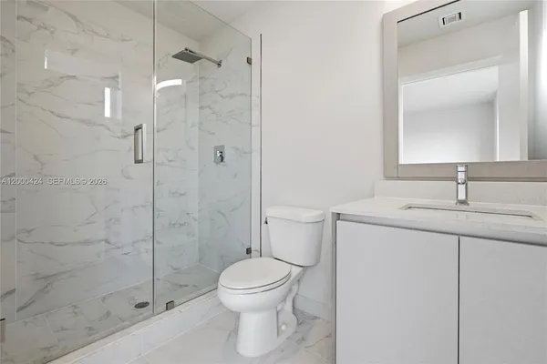 an empty room with closet and a bathroom