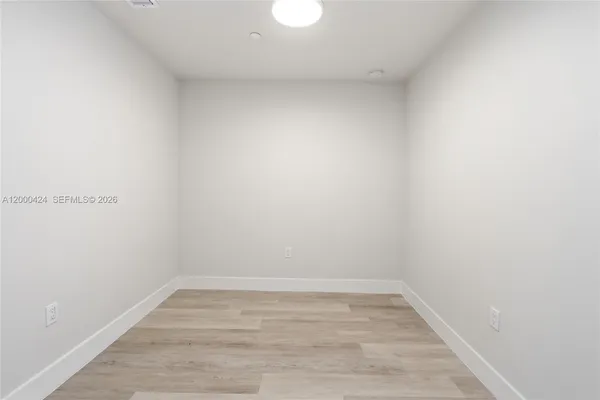 a view of a storage & utility room with wooden floor