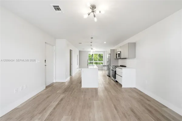 a view of kitchen with wooden floor and window