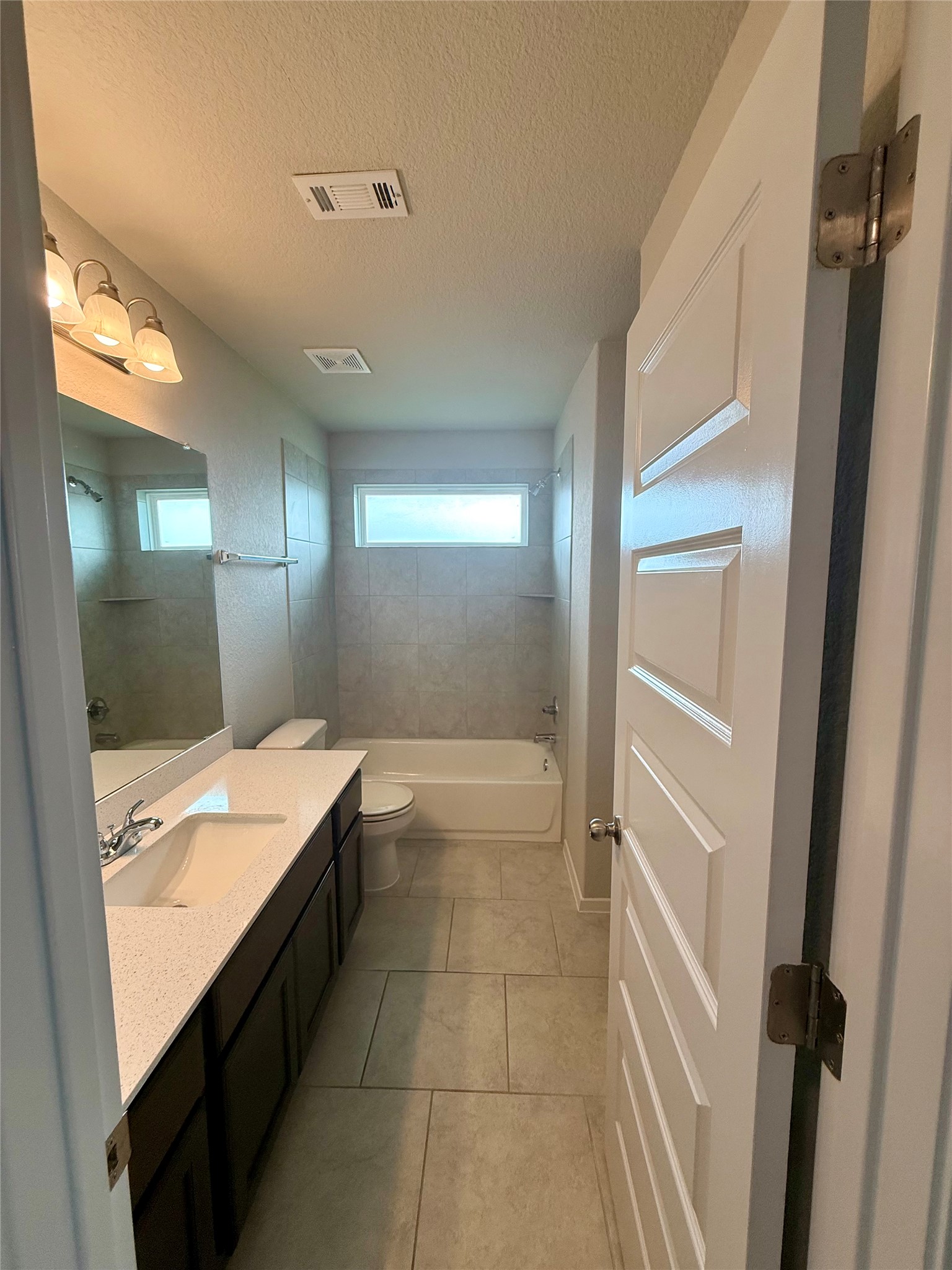 212 Lake Placid Run Elgin, TX 78621 - Photo 22 of 27 A well-lit bathroom features a spacious vanity and a sparkling tub, offering everyday convenience.