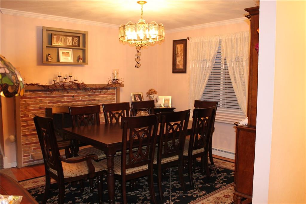 125 Meadowbrook Road Renfrew, PA 16053 - Photo 6 of 18 Diningroom main floor with gas fireplace and hardwood floors