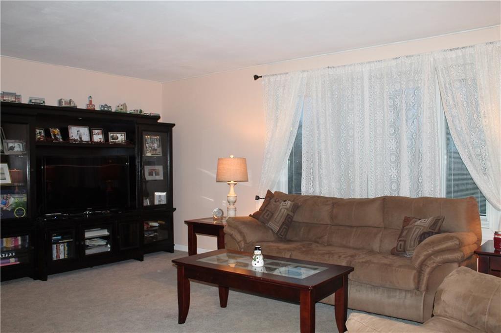 125 Meadowbrook Road Renfrew, PA 16053 - Photo 8 of 18 Upper level of home Large living room with wood burning fireplace and Pella Bay window