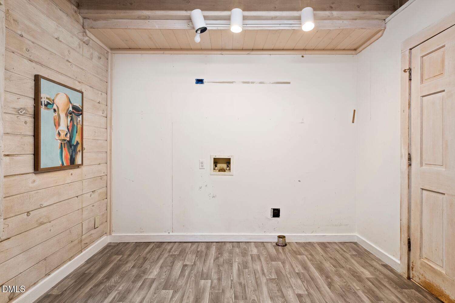 7391 Howerton Road Elon, NC 27244 - Photo 30 of 53 Wood-finish flooring, wood plank accent wall, track lighting, wood-paneled ceiling, and a paneled door