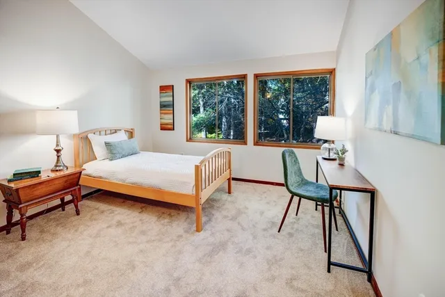 a bedroom with a bed and a large window