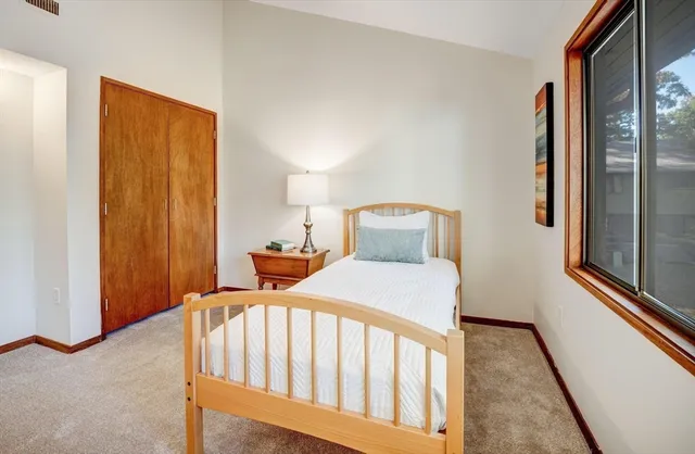 a bedroom with a bed and a window