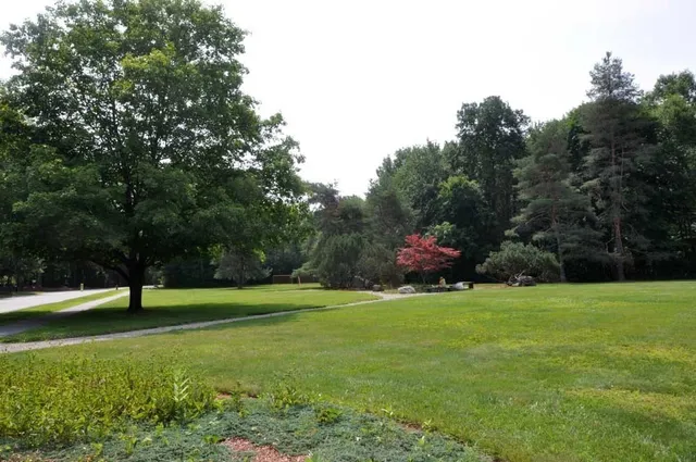 a backyard of a house with table and chairs