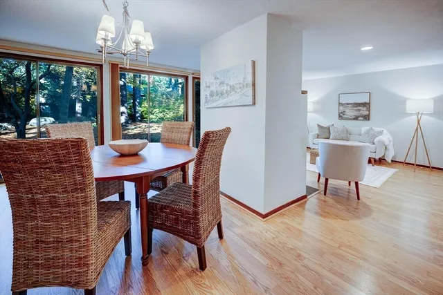 a view of a dining room with furniture wooden floor and a chandelier