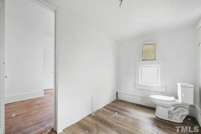a view of an empty room and wooden floor