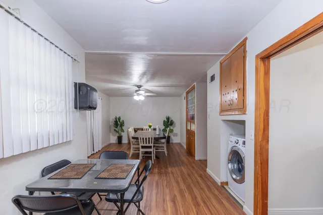 a dining room with furniture and wooden floor