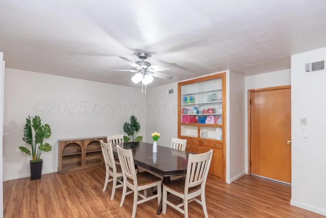 a view of a dining room with furniture and wooden floor