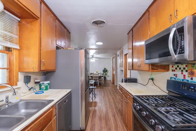 a kitchen with a sink and wooden cabinets