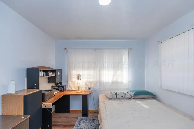 a room that has a bed and a table in it