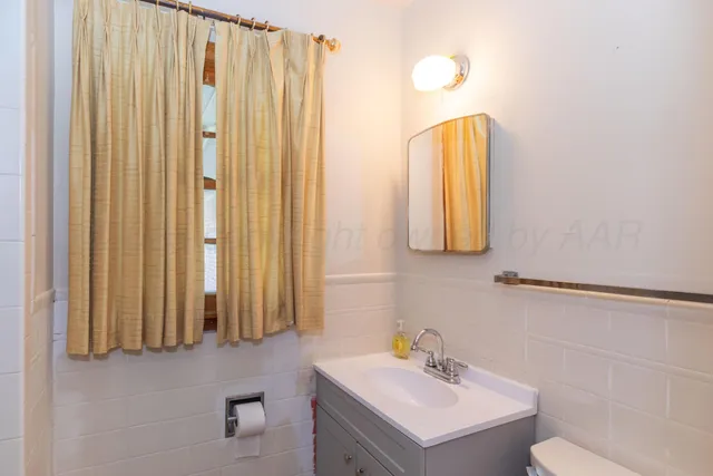 a bathroom with a sink vanity and a mirror