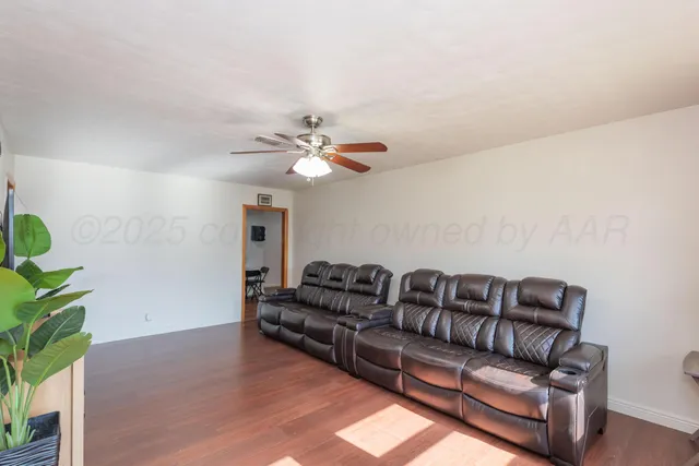 a living room with furniture and wooden floor
