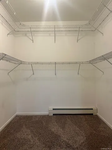 a bathroom with a sink a toilet a mirror and shower