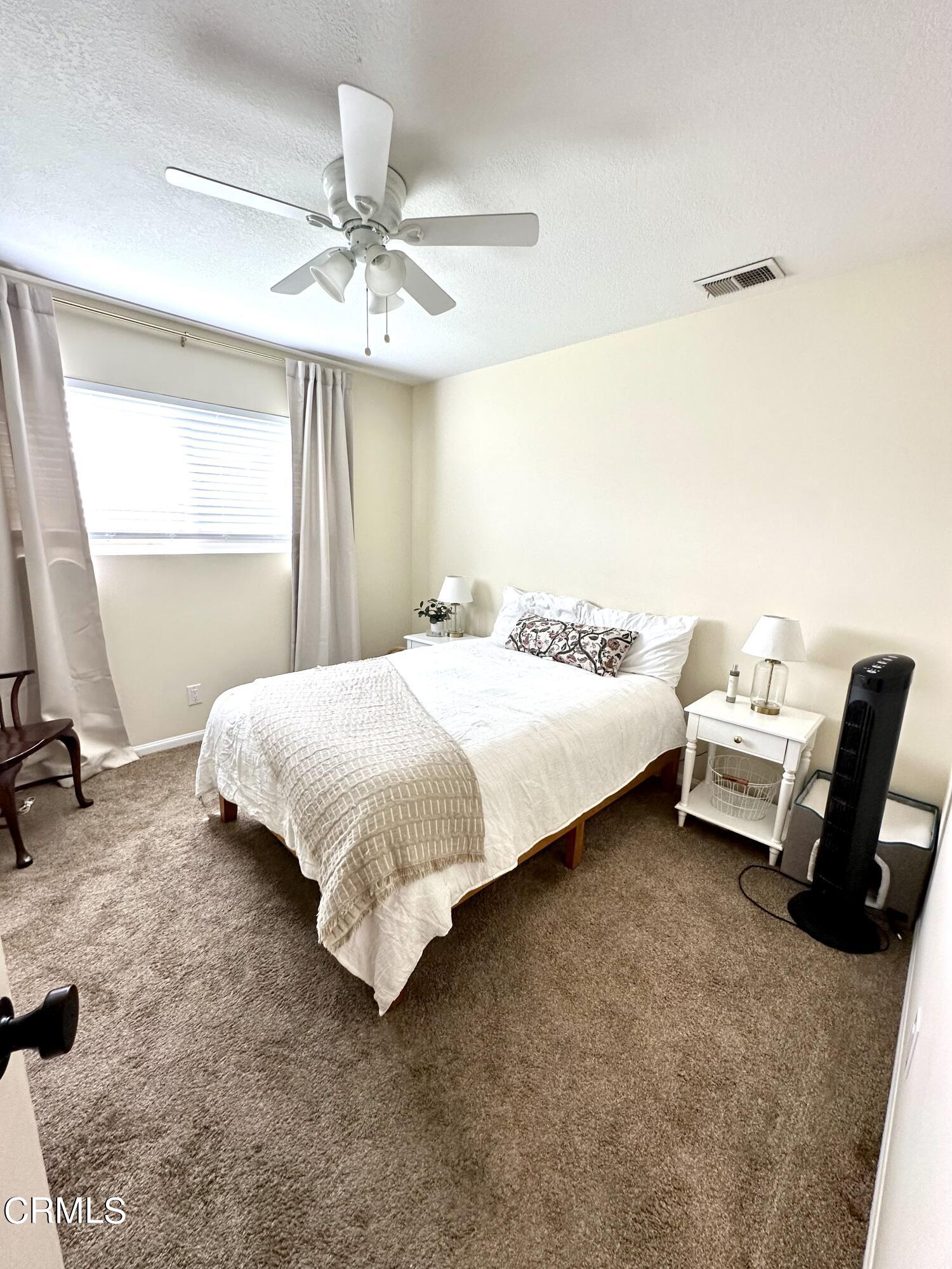 4621 Hamilton Avenue Oxnard, CA 93033 - Photo 11 of 22 a bedroom with a bed and a chandelier