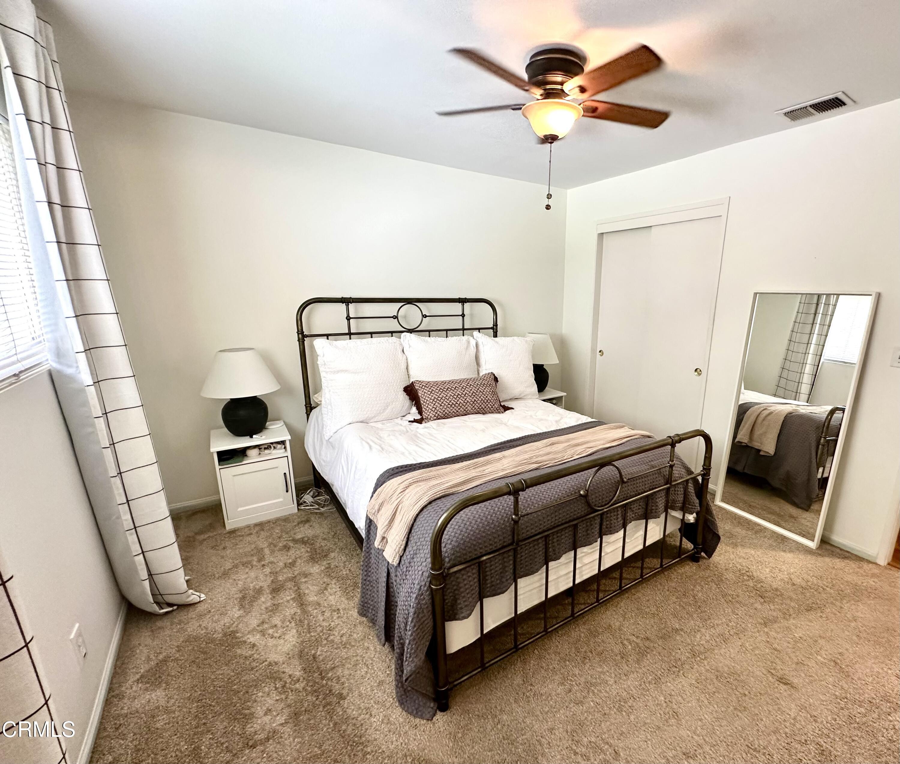 4621 Hamilton Avenue Oxnard, CA 93033 - Photo 16 of 22 a bedroom with a bed and a chandelier