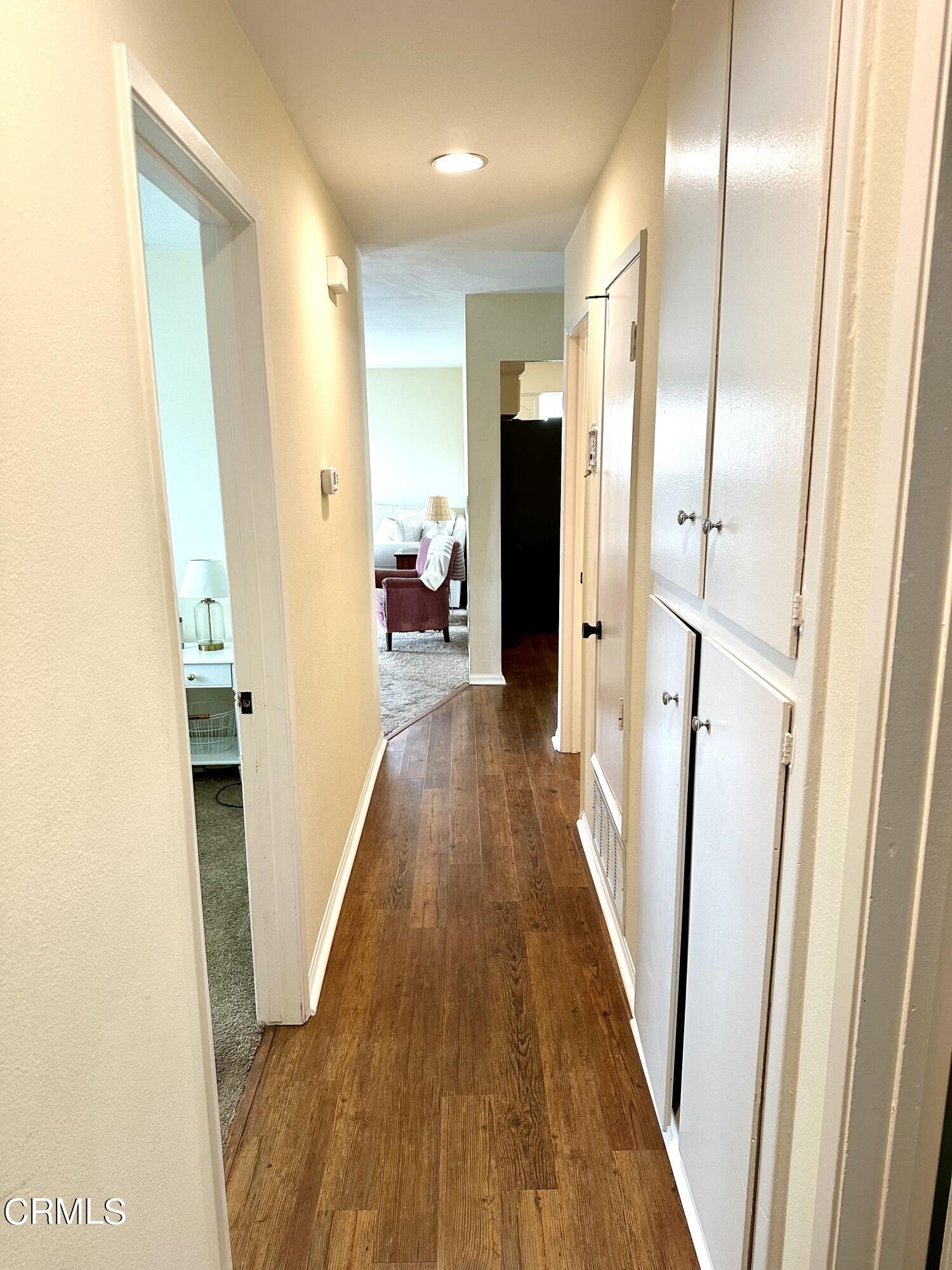 4621 Hamilton Avenue Oxnard, CA 93033 - Photo 17 of 22 a view of a hallway with wooden floor and staircase