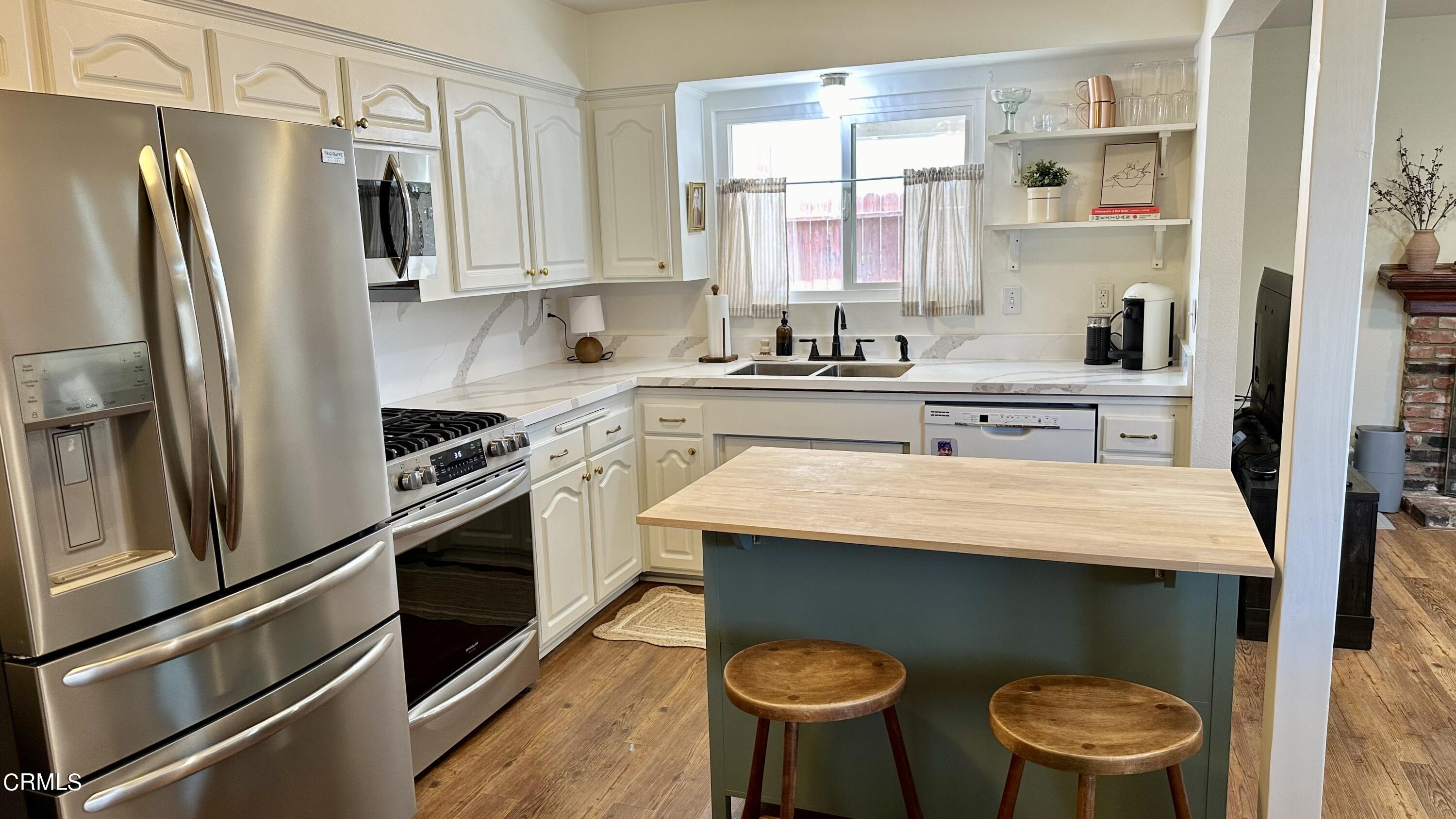 4621 Hamilton Avenue Oxnard, CA 93033 - Photo 3 of 22 a kitchen with stainless steel appliances a sink stove and refrigerator