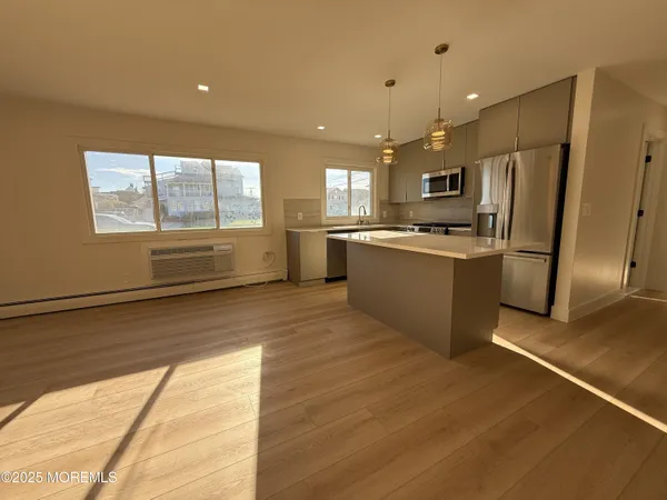 a kitchen with stainless steel appliances granite countertop a refrigerator and a stove top oven